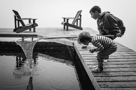 Lake fishing in the early morning fog