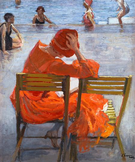 Young woman in a red dress at a swimming pool